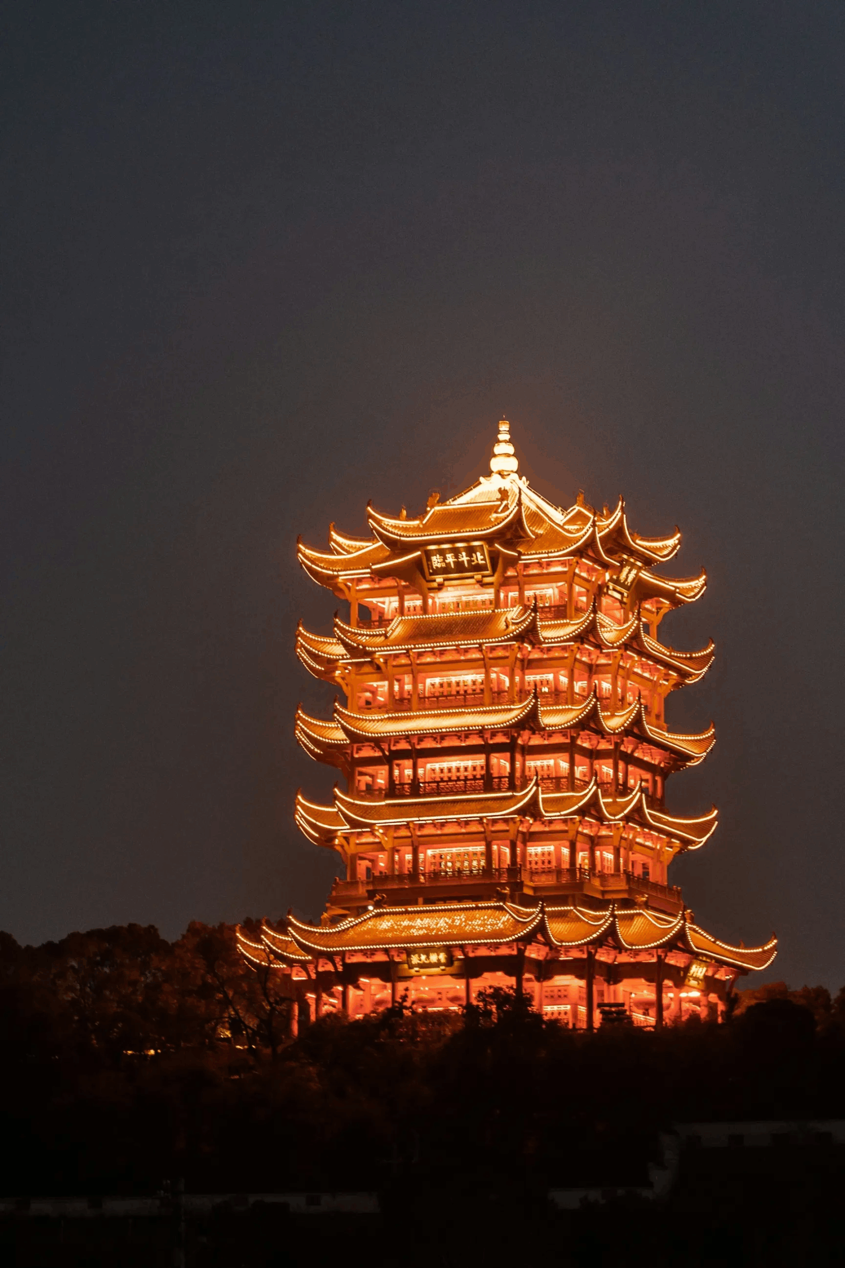 Yellow crane tower in China lit up at night